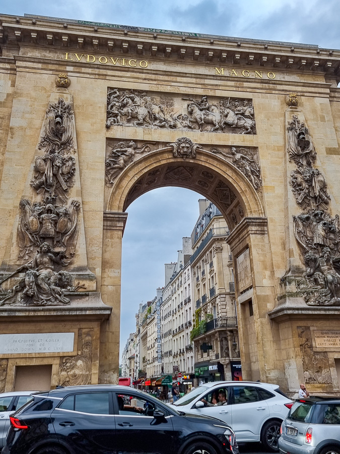 The St. Denis Gate, a fragment remaining of the medieval city's walls, gives a different view of the martyr. Passing drivers don't seem to register the historical significance of this.